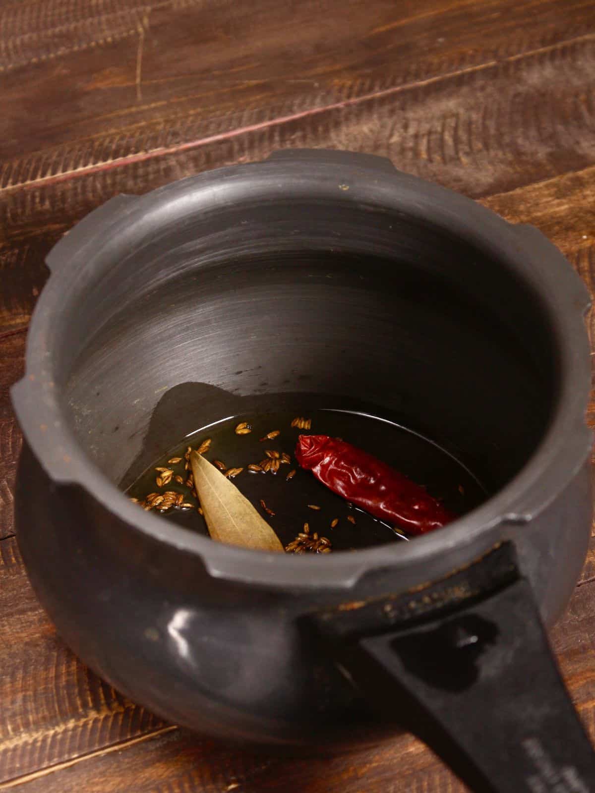 cumin seeds with oil in a pot